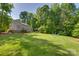 A sprawling backyard with a fire pit, wooden fence, and home with a deck at 3243 Farmcrest Ct, Fort Mill, SC 29708