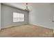 Bedroom with plush carpeting, a chandelier, and a large window at 3243 Farmcrest Ct, Fort Mill, SC 29708