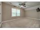 Bright, neutral bedroom with a large window and a ceiling fan with light fixture at 3243 Farmcrest Ct, Fort Mill, SC 29708