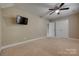The bedroom features a modern ceiling fan, TV, and two closets for ample storage at 3243 Farmcrest Ct, Fort Mill, SC 29708