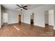 Spacious bedroom with hardwood floors and ceiling fan, connected to a walk-in closet at 3243 Farmcrest Ct, Fort Mill, SC 29708