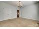 Bedroom with plush carpeting, a chandelier, and double closets at 3243 Farmcrest Ct, Fort Mill, SC 29708