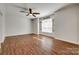 Spacious bedroom with hardwood floors, a ceiling fan, and abundant natural light at 3243 Farmcrest Ct, Fort Mill, SC 29708