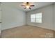Bedroom with plush carpeting, a ceiling fan, and a large window at 3243 Farmcrest Ct, Fort Mill, SC 29708