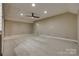 A versatile bonus room showcases neutral walls, carpet, a ceiling fan, and recessed lighting at 3243 Farmcrest Ct, Fort Mill, SC 29708