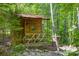 Cozy wooded cabin featuring a small porch, outdoor seating and ample privacy at 3243 Farmcrest Ct, Fort Mill, SC 29708