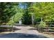 Private driveway with charming gate leading to the home and detached garage at 3243 Farmcrest Ct, Fort Mill, SC 29708