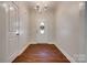 Bright entryway featuring hardwood floors, chandelier, and decorative front door at 3243 Farmcrest Ct, Fort Mill, SC 29708
