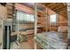 Rustic cabin interior with bunk beds, wood-burning stove, and natural wood walls at 3243 Farmcrest Ct, Fort Mill, SC 29708