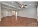 Open living room with hardwood flooring, coffered ceiling, and a view of the entryway at 3243 Farmcrest Ct, Fort Mill, SC 29708