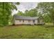 Backyard with a deck, a well-maintained lawn, and mature trees at 3585 Goodman Lake Rd, Salisbury, NC 28146