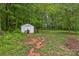 View of backyard area showing shed surrounded by lush greenery at 3585 Goodman Lake Rd, Salisbury, NC 28146