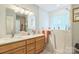 Bright bathroom featuring a walk-in tub, a double vanity, and a large window at 3585 Goodman Lake Rd, Salisbury, NC 28146