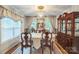 Dining room featuring a long table, a chandelier, a cabinet and large windows at 3585 Goodman Lake Rd, Salisbury, NC 28146