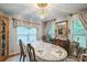 Dining room with chandelier and a long table topped with elegant place settings at 3585 Goodman Lake Rd, Salisbury, NC 28146