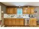 Kitchen with wooden cabinets, quartz countertops, stainless steel dishwasher and double sink at 3585 Goodman Lake Rd, Salisbury, NC 28146