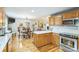 Open kitchen boasts wooden cabinets, quartz countertops, and stainless steel oven at 3585 Goodman Lake Rd, Salisbury, NC 28146