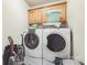 Functional laundry room with washer, dryer, and upper cabinets for storage at 3585 Goodman Lake Rd, Salisbury, NC 28146