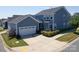Rear exterior view of blue house featuring a detached garage and a well kept lawn at 3588 County Down Ave, Kannapolis, NC 28081
