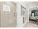 Bathroom with a shower featuring gray tile and a built-in shower caddy at 3588 County Down Ave, Kannapolis, NC 28081