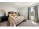 Comfortable bedroom featuring a large bed with dark wood side tables and lamps at 3588 County Down Ave, Kannapolis, NC 28081