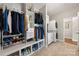 Walk-in closet features custom shelving and organization system with washer and dryer at 3588 County Down Ave, Kannapolis, NC 28081