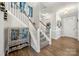 Inviting foyer with staircase, hardwood floors, and decorative cabinet at 3588 County Down Ave, Kannapolis, NC 28081