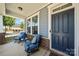 Cozy front porch with blue chairs, plants, and decor, perfect for relaxing outdoors at 3588 County Down Ave, Kannapolis, NC 28081