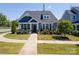 Charming blue home with a well-manicured lawn, walkway, and inviting front porch at 3588 County Down Ave, Kannapolis, NC 28081