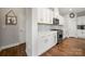 Modern kitchen with white cabinets, stainless steel appliances, and hardwood floors at 3588 County Down Ave, Kannapolis, NC 28081