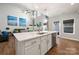Modern kitchen island with stainless steel appliances, quartz countertops, and stylish pendant lighting at 3588 County Down Ave, Kannapolis, NC 28081
