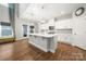 Bright kitchen features a large island with quartz countertops, stainless appliances, and pendant lighting at 3588 County Down Ave, Kannapolis, NC 28081