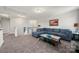 Comfortable living room with plush blue sectional sofa, carpet, and a glass-topped coffee table at 3588 County Down Ave, Kannapolis, NC 28081