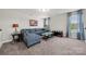Spacious living room with plush blue sectional sofa, carpet, and a glass-topped coffee table at 3588 County Down Ave, Kannapolis, NC 28081