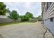 Large concrete backyard with fencing, trees, and partial home view at 3602 Brookstone Trl, Indian Trail, NC 28079