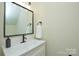 Bright bathroom featuring a sleek white vanity, stylish black fixtures, and a modern square mirror at 3602 Brookstone Trl, Indian Trail, NC 28079