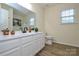 Bathroom with double vanity sink, white cabinets, and plenty of light at 3602 Brookstone Trl, Indian Trail, NC 28079