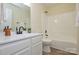 Bathroom showcasing a white vanity with modern fixtures, toilet and a tub with a shower head at 3602 Brookstone Trl, Indian Trail, NC 28079