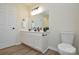 Bathroom showcasing white vanity cabinets, a mirror, and modern fixtures at 3602 Brookstone Trl, Indian Trail, NC 28079