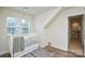 Bright and cozy room with a white crib near a window, enhanced by hardwood flooring at 3602 Brookstone Trl, Indian Trail, NC 28079