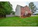 Well-maintained brick home with red shutters, an attached garage, and green lawn at 3602 Brookstone Trl, Indian Trail, NC 28079
