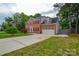 Traditional brick home boasts a spacious driveway, two-car garage, and manicured lawn at 3602 Brookstone Trl, Indian Trail, NC 28079