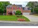 Charming brick home featuring red shutters, a well-manicured lawn, and a two-car garage at 3602 Brookstone Trl, Indian Trail, NC 28079