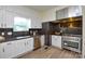 Kitchen features modern appliances, granite counters, ample cabinet space, and hardwood floors at 3602 Brookstone Trl, Indian Trail, NC 28079