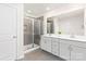 Modern bathroom with a glass-enclosed shower, double vanity, and gray tile accents at 363 Cedar Knoll Cir, Pineville, NC 28134