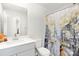 Clean bathroom featuring a white vanity, toilet, and a shower with a decorative Parisian themed curtain at 363 Cedar Knoll Cir, Pineville, NC 28134