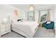Bright bedroom with a decorative chandelier, plush pillows, and a comfortable sitting area by the window at 363 Cedar Knoll Cir, Pineville, NC 28134