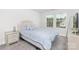Guest bedroom featuring a queen size bed, mirrored nightstand, and bright windows at 363 Cedar Knoll Cir, Pineville, NC 28134