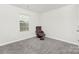 Cozy bedroom with carpeted floor, featuring a comfortable brown leather recliner and natural light from a window at 363 Cedar Knoll Cir, Pineville, NC 28134