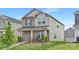 Attractive two-story home features brick accents, a covered front porch, and a green lawn at 363 Cedar Knoll Cir, Pineville, NC 28134